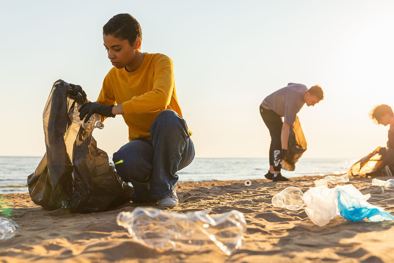 Conservation workers cleaning plastic off a beach