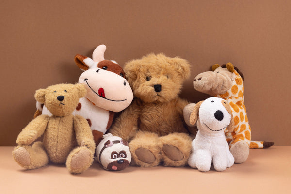 Various stuffed animals against a brown background